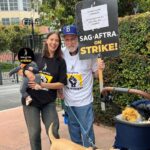 Kristen Gutoskie Instagram - One day longer, one day stronger @sagaftra !!! Flash back to family picket last week with Lenny, puppa Mingus and grandpapa Boehner -our retired teamster coming to support ❤️ #sagaftrastrong #onedaylongeronedaystronger