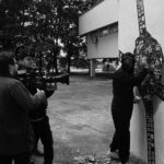 Lado Kvataniya Instagram - Пока мы выводили проекцию на высотку, за нашими спинами происходило задержание группы лиц неопределённой национальности. Сотрудники уверено вязали молодых людей, положив их лицами на капот. Нас они старательно не замечали, а мы взаимно игнорировали их в ответ. Было у нас на все не больше часа, но как это обычно случается вся техника магическим образом отказывалась работать. Проектор весит под 100 килограмм, а нам его надо повернуть набок, чтобы вывести проекцию в нужном положении. Потом он и вовсе перестал включаться. Коптер глушили фсо-шные вышки. Он взлетал на 10 метров и тут же терял управление. Стали поступать предложения сделать проекцию на CG, но я отказывался верить. Все должно быть по-настоящему! Когда еще нам выпадет возможность вывести гигантские лица поэтов на сталинскую высотку? В самый последний момент, когда времени практически не оставалось, нам удалось снять запланированые кадры. Каждый раз, когда я проезжаю мимо этой величественной постройки, то на фасаде здания я “вижу” нашу проекцию. Виртуальная подпись, которую мы оставили всей нашей командой • Backstage from @klepnev | #noizemc #почитайстарших #hypeproduction