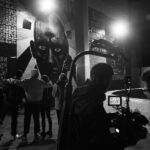 Lado Kvataniya Instagram - Пока мы выводили проекцию на высотку, за нашими спинами происходило задержание группы лиц неопределённой национальности. Сотрудники уверено вязали молодых людей, положив их лицами на капот. Нас они старательно не замечали, а мы взаимно игнорировали их в ответ. Было у нас на все не больше часа, но как это обычно случается вся техника магическим образом отказывалась работать. Проектор весит под 100 килограмм, а нам его надо повернуть набок, чтобы вывести проекцию в нужном положении. Потом он и вовсе перестал включаться. Коптер глушили фсо-шные вышки. Он взлетал на 10 метров и тут же терял управление. Стали поступать предложения сделать проекцию на CG, но я отказывался верить. Все должно быть по-настоящему! Когда еще нам выпадет возможность вывести гигантские лица поэтов на сталинскую высотку? В самый последний момент, когда времени практически не оставалось, нам удалось снять запланированые кадры. Каждый раз, когда я проезжаю мимо этой величественной постройки, то на фасаде здания я “вижу” нашу проекцию. Виртуальная подпись, которую мы оставили всей нашей командой • Backstage from @klepnev | #noizemc #почитайстарших #hypeproduction