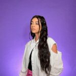 Lilly Singh Instagram – It’s Diwali season 🪔
The holiday season always has me reflecting on what love and light mean to me. Here are a few thoughts that have been floating around in my head. This may not resonate with all of you, but if it inspires a few, then great.
Kindness is so underestimated. Being kind to a stranger you pass, a friend who is in need, or literally anyone you connect with in your day is important and valuable. Will any of these small acts of kindness I do solve all the worlds big problems? Probably not. But does that mean they don’t matter? That can’t be right. We have to value kindness. All of it matters.
Love and light are infinite when we are a collective, but individually no one has enough light to shine on everything or everyone. But that doesn’t mean we should succumb to darkness and do its bidding. Perhaps that divisive behavior is exactly what darkness wants?
I think about this because I reflect on that last time I felt my light dim. It was when I came back from my recent India trip. The purpose of this trip was to shine light onto issues I care deeply about. I met girls who were married off at 13 years old, unable to go to school. Although these girls were made of pure light, the circumstances felt dark to me and I carried that energy back home with me. I remember coming home and being upset… at everything and everyone. I picked fights with my parents. I snapped at my friends. Upon reflection, I hold grace for myself because I’m only human, but I also recognize that none of that behavior helped a single girl back in India. You cannot fight darkness with more darkness.
Another thing I don’t know for certain is how to tackle all of the darkness in the world. When we talk about light overcoming dark, good overcoming evil.. it feels so overwhelming because there are countless examples of darkness running rampant. But even in the midst of that confusion, one thing I do know for certain is that love and light have to be part of the answer. And love and light matter, because there are also countless examples where good is thriving in this world.
Wishing those who celebrate a very happy start to the Diwali season 💜