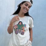 Lilly Singh Instagram - Maybe if I just play with my necklace a little… okay good, yes. And then maybe look away into space as if I’m pondering. Nailed it. One hand in pocket. Good, good. Adjust the hat a bit perhaps? Is this good? Wait, let me lean in a tad too on the side that hides my pimple. Perfffff. Boom. Candid. Natural. Sorry, just love my fit too much today. Monochromatic cream? It’s giving, “I carry a Tide pen in my pocket.” Ufffff. Grab yourself a “Books Over Bakwaas” t-shirt or sweater. For a limited time. Link in bio. 🔗 20% of proceeds go to @unicornisland Fund to help girls and women in India live life to their fullest potential (including literacy skills!) We love a full circle fashion-giveback moment. #GivingTuesday #LillysLibrary #HoliChic