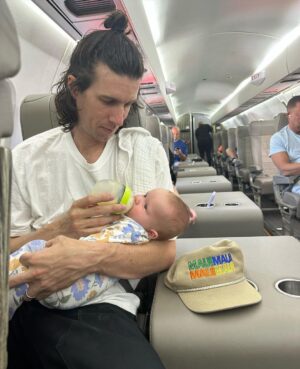 Liz Trinnear Instagram - Nico’s first plane ride & trip to California ☀️💕🥹
.
1. Pre plane ride pep talk
2. Snackin’ on the plane with dad
3. Uncle David came to pick us up!
4. Cuddles with Uncle Davie
5. One for caffeine, one for “we did it!” 
6. Uncle Sean!
7 & 8. Daddy time 💕
9. Hanging with bestie Auggie