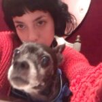 Lola Blanc Instagram - My best friend @rambosgettingold finally got too old. The dreaded day finally came, and Rambo crossed the Rambo bridge on Tuesday. My Ram, my ham, my tiny man, was nearly 16; he was in pain and it was time. The silliest boy got me through my 20s, four breakups, and a pandemic, and I’ll always be grateful to him for that. I’m gonna miss his morning wiggles, my favorite part of the day. I’ll cherish stumbling on him buried in piles of clothes in my messy closet every day, feeling him climb up behind me to be my neck pillow while I worked, and how annoyed he’d get when I’d force him to snuggle. (I got one last annoying snuggle in, pictured here.) And I’ll never understand how a dog could be prideful about letting us help him on the bed, but that was Ram. Spry until the end. @timothy_lee_ found this video he made when he was a puppy, in slide 2, and it’s perfectly Rambo. Highly recommend. He was a calming travel companion, a talented model, and an expert hair stylist, and even in his old age, even this week, people would comment on how young he seemed. He was the funniest, cutest guy and such an integral part of my life. The place feels a lot emptier without you, baby boy. Thanks for waiting until I could handle it. I’ll love you forever.