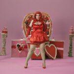 Lucy Loone Instagram - i feel so right in red 🫦😂💋 stills from the king of hearts scene in the “eat it up” music video directed by me shot by @jasonbanker , costume by @eddysonline , hair by @neciashairstyling layed down by @ravenvalentinee ♥️ set design by @alfredospookyart , 💅 & 💄 by me 🔗 IN MY B1O , go do ur daily watch n share the song n vidd with ur friends 🎀🎀🎀💋