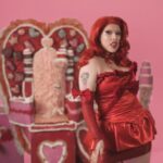 Lucy Loone Instagram - i feel so right in red 🫦😂💋 stills from the king of hearts scene in the “eat it up” music video directed by me shot by @jasonbanker , costume by @eddysonline , hair by @neciashairstyling layed down by @ravenvalentinee ♥️ set design by @alfredospookyart , 💅 & 💄 by me 🔗 IN MY B1O , go do ur daily watch n share the song n vidd with ur friends 🎀🎀🎀💋