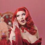 Lucy Loone Instagram - i feel so right in red 🫦😂💋 stills from the king of hearts scene in the “eat it up” music video directed by me shot by @jasonbanker , costume by @eddysonline , hair by @neciashairstyling layed down by @ravenvalentinee ♥️ set design by @alfredospookyart , 💅 & 💄 by me 🔗 IN MY B1O , go do ur daily watch n share the song n vidd with ur friends 🎀🎀🎀💋
