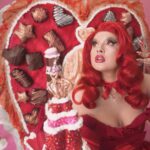 Lucy Loone Instagram - i feel so right in red 🫦😂💋 stills from the king of hearts scene in the “eat it up” music video directed by me shot by @jasonbanker , costume by @eddysonline , hair by @neciashairstyling layed down by @ravenvalentinee ♥️ set design by @alfredospookyart , 💅 & 💄 by me 🔗 IN MY B1O , go do ur daily watch n share the song n vidd with ur friends 🎀🎀🎀💋