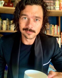 Luke Arnold Instagram - Happy #Audies2021 from the shed carpet! A ridiculous honour to be nominated. I love narrating the Fetch Phillips Archives and can’t believe my work has been included alongside such amazing authors and narrators. If you haven’t listened to The Last Smile in Sunder City yet, go grab it! @hachetteaudio @orbitbooks @squaresoundstudio