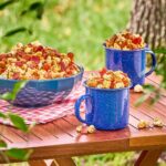 Luke Bryan Instagram – Excited for y’all to try out @farmlandfoods’ Maple Bacon Kettle Corn on #FarmTour2023. Come out to the Farmland Outdoor Adventure area or make it yourself with the recipe below:

Farmland Maple Bacon Kettle Corn
Prep time: 5 minutes
Cook time: 10 minutes
Serves: 4

Ingredients: 
12 oz. Farmland Premium Maple Thick Cut Bacon, diced
3 tbsp. Vegetable Oil
3/4 cup Popcorn Kernels
3 tbsp. Light Brown Sugar, loosely packed
2 cups Honey Roasted Peanuts 

Directions:
1. Heat a skillet over medium-high heat and render the bacon pieces until crispy, then drain on paper towels.
2. Heat a heavy-bottomed pot over medium-high heat and add the oil. Heat until the oil just begins to shimmer.
3. Add the popcorn kernels in an even layer in the oil, then sprinkle the brown sugar evenly over the top.
4. Cover with a lid, leaving a crack for steam to vent, shaking occasionally until the kernels begin to pop.
5. Once the popcorn begins popping in earnest, shake constantly.
6. When the popping slows to 1 kernel per second, remove and dump immediately into a large bowl.
7. Add the rendered bacon and peanuts, and toss to combine.
8. Serve immediately, or allow to cool to room temperature and store for up to 2 days in an airtight container.
