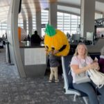 Mandy Moore Instagram - Find yourself a partner who will do whatever it takes to keep the kids entertained at the airport. You’re the best, @taylordawesgoldsmith. 🍍. PS- seeing some of the comments and I’m dying…it was a decoration at our gate and they said he could put it on!! He definitely did not pack it 😂😂😂