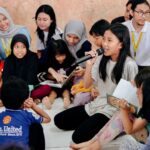 Maudy Ayunda Instagram - Berkunjung ke Sekolah Jingga untuk membacakan buku cerita Kina ke audience yang menggemaskan. Momen yang sederhana tapi penuh warna, dengan adik2 yang percaya diri dan penuh semangat. Di post ini aku mau angkat topi buat temen-temen dari inisiatif community development BEM Fisip UI, Tarida dan teman-teman yang meluangkan beberapa jam di setiap hari minggu untuk mengajar dan bermain dengan anak-anak di Sekolah Jingga, yang mungkin membutuhkan support lebih dengan keterbatasan yg ada. 💕