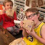 Meaghan B. Murphy Instagram - There’s still time to pull off this #kidstable #thanksgiving #craft! How to: Fill a brown paper bag with popcorn 🍿 (and maybe some leftover Halloween candy!), twist the top closed + tape a piece of white computer paper around it; fray the edges. You can add names with stickers to use as fun name cards at place setting 🍽...but Team Murphy got hungry! 🦃 #thanksgiving #diy #kidstable #wdcelebrates #womansday #placecards #namecards #turkeylegs Thanksgiving Dinner