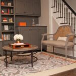 Meaghan B. Murphy Instagram - 🚨NEW 🏡 PROJECT🚨 Sometimes you need to fix 🛠️something that isn't broken just because it no longer works FOR YOU. That was the case with this sitting room. I loved the original design, but in 5 years NO ONE actually EVER sat in the sitting room. So, here's what we did to change that because with 3 kids and a dog we need to eek out every ounce of living space in our home: 🪑 First up, more functional furniture. We said goodbye to my oversized family heirloom chair (luckily Nana was excited to put it in her bedroom) and banished the stuffy (but pretty!) bench to my office. I saw these navy @potterybarn swivel chairs at my girlfriend's house and ordered them immediately. I have grown to appreciate the entertainment value of a swivel. Then I was at a loss, so I called in @thehavenly for a little design hand-holding. Havenly helped me land on this @arhaus table + ottomans & approved my striped @potterybarnkids rug choice (I needed the validation). WOWZA! Suddenly this space became a cozy spot for morning ☕️ after-dinner 🫖 and unwinding w/ a 🍷 where I can stare at my guitar 🎸 and the lyrics to Blackbird 🐦‍⬛ and manifest playing it someday. I think lessons would help. LOL The other big change here was brightening up the bookcases with a fresh coat of white. 🎨 I think it makes my book 📕 ⚡️& beloved knickknacks pop. Leave it to @shadyladycolors and @amazingpaintingnj to make the magic 🪄 happen. We also added battery-operated book lights from @lampsplus that make me endlessly happy at night. 💡 Finally, @ellaallure killed it with the Dempsey-friendly performance fabric cushion in just the right orange-y shade + fun patterned pillows. What do you think? I love that my friend @sarapeterson_thenext who founded HGTV mag calls small projects like this a "Twirl Up." I'm working on a whole issue of @womansdaymag devoted to mini makeovers like this. If you have a project to share, DM or email me! #makeover #homeproject #homerenovation #homerenovations #homeprojects #painting #bookshelves #arhaus Home Sweet Home