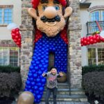 Meaghan B. Murphy Instagram - Mamma Mia! My fully charged friend ⚡️Danielle (p. 177 of YFCL) + @dreamfactoryballoons 🎈have outdone themselves once again to raise $ and awareness for @crohnscolitisfoundation_nj For the 10th year, friends and neighbors are invited to tour the balloon fantasy land, spin the wheel, win a prize & make a donation for the Crohn's and Colitus Foundation. Danielle started the tradition as a way of coping after their 9-year-old was diagnosed with the disease. I celebrate + admire her for channeling pain into purpose. It feels good to do good! Click the donation button to give back. And in case you were wondering, my last-minute costume = French Kiss! Get it: Beret + Kiss concert tee! #balloonart #balloons #halloween #crohnsandcolitis #bestfieldnj #kiss #mariobrothers Westfield, New Jersey