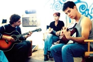 Michael Imperioli Instagram - Teaching actor JAMES DUVAL the chords to The Killing Moon as make-up artist LORENA LOPEZ looks on.  This was on the set of the rarely seen indie film A RIVER MADE TO DROWN IN. -Hollywood, CA,  Autumn of 1996. @realjamesduval #arivermadetodrownin