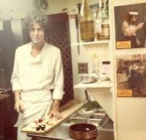 Michael Imperioli Instagram - Anthony Bourdain in the kitchen and Harvey Keitel in Taxi Driver over Tony’s left shoulder.  I love this photo as it includes two people I will always hold in very high esteem. After I read Kitchen Confidential I sought Tony out  in hopes of making it into a series or a film. It was difficult but I managed to track him down. I can be relentless when I am on a mission, and lo and behold he invited me to lunch at Le Bernadin, his pal Eric Ripert’s (a dharma brother) stellar restaurant in Midtown. When I arrived, Tony was waiting and watching stealthily a few doors down,  leaning against the wall, smoking a cigarette. We walked in together and Eric fed us a seven course lunch with different wines for every dish…it was epic and revelatory. Tony and I connected right away on music, books, movies and NYC lore. Finally he asked why I reached out. I told him that I had worked in nyc restaurants for 9 years, as a prep cook, line cook, bus boy, food runner, waiter, bartender and deli counter man. I said that his book was so honest, accurate, articulate and entertaining that I thought it should be a film or a series. But sadly I was too late. He told me he had already sold it to Fox who fucked it up royally. It died on the TV trash heap having been fed through the Hollywood meat grinder. But the five hour lunch with Tony was unforgettable and well worth whatever effort I made to find him. He was a gem. @friendsofanthonybourdain #anthonybourdain #ericripert #lebernardin @ericripert @lebernardinny @anthonybourdain