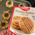 Mo Collins Instagram - Betty Crocker fucked up. Bought 3 packages for 3 dozen. Only (barely) made 2. Wouldn’t mix into a good dough. Crumbly!! (Yes, I triple checked instructions) Says 8-10 minutes but hadn’t even begun baking until 10. Took them out at 12, already sensing failure. They’re crumbling apart. Stuck to bake sheet. Total disaster. Cookie party is in 2 hours. Betty Crocker is trying to break my Christmas spirit. Not today, Betty!! Not today!!!!! #bettycrocker #christmascookies #hersheykisses #baking #bakingcookies #comedy #christmasparty #holidaybaking