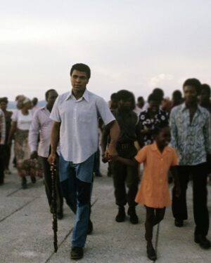 Muhammad Ali Instagram - Muhammad Ali walking with youth fans along the River Zaire before his fight vs George Foreman at the presidential complex outside of Kinshasa. ⁣
⁣
N'Sele, Zaire – October 1974.⁣
⁣
📸: @neilleiferphotography⁣
⁣
 ⁣
#MuhammadAli #Icon #RumbleintheJungle #MuhammadAlivsGeorgeForeman #Boxing #Legendary #GOAT #Champion