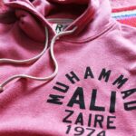 Muhammad Ali Instagram - "Ali, boma ye! Ali, boma ye! Ali, boma ye!"⁣ ⁣ Muhammad Ali heard it all as music and danced. Then he came off the ropes and struck. The “Rumble in the Jungle” stands as boxing’s singular work of art. And that night in Zaire, Ali — The Greatest that ever was — rendered all those saying all those things speechless. An underdog? They didn’t know Ali. In over his head against George Foreman? They didn’t know Ali. A washed up champion who lacked humility? They didn’t know Ali.⁣ ⁣ Oct. 30, 1974, we all found out. @rootsoffight honors the most iconic boxing event of all time with this special edition pink rumble hoody.⁣ ⁣ Link in story!⁣ ⁣ ⁣ #MuhammadAli #RumbleInTheJungle #RootsofFight #KnowYourRoots