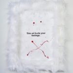 Nadezhda Tolokonnikova Instagram - This art is a hammer that shapes reality (series) 🩸🔨 2023 The text is printed on fabric. I use textile because traditionally it was labeled as low art/crafts, female work - and because I was forced to work with textile in my penal colony. The fabric is stapled to canvas, and pink and white fur is stapled to canvas as well. I use pins, needles, and parts of the sewing machine in this series, finally fulfilling my prison dreams about getting new sets of needles - now I'm a free person and can just order them online, it was a big pleasure ordering them! "We can't give you new needles and parts to fix your machine, did you forget where you are? You're in RUSSIA" - I was told in prison when I asked to fix my equipment. Splashes of acrylic paint on the fabric are reminiscent of my blood getting spilled on police and military uniforms that I was sewing in prison, injured by old and outdated equipment. For more solid red paint coverage - like in "This art screams in pain" piece - I used red spray paint, a tool that was widely used in my activist anarchist youth. Teddy bears are penetrated with needles like my fingers used to be when I was sewing in prison, teddy bears are covered in Putin's Ashes - I saved a bucket of ashes after the performance in August 2022 and now use it as art material. I combine cute and dangerous, playful and serious in this series, just like we did in our name, Pussy Riot. The harsh statements are combined with plush toys and faux fur 💣🐁 Once Marina Abramovic asked me why I like baby pink so much, she hates baby pink. I said that I want to look cute when cops are arresting me, I want them to look stupid. She said, ok, you're the only person I can accept wearing baby pink and hello kitty backpacks.