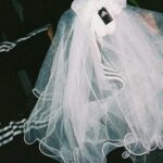 Nadezhda Tolokonnikova Instagram - 💍🔪🫀 american boy уеду с тобой @voguemagazine 📝: Sewing used to be a source of trauma for Pussy Riot’s Nadya Tolokonnikova, who was forced to stitch military and police uniforms while in a Russian penal colony. But she decided to reclaim the activity when she sewed Adidas stripes onto her now-husband John Caldwell’s suit jacket, for their wedding on 12 January. “Now I feel like I can sew again without being necessarily connected to the traumatic experience,” she says. “It broke the chain of trauma.” She wanted to create contrast between the “cute” side of her personality with the “gopnik” side. Tolokonnikova, who is vegan, juxtaposed her sweet look with an oversized black faux-leather Adidas jacket. She also wore a pair of velvet Doc Martens, though she changed into slides from—you guessed it—Adidas during the party. Tolokonnikova also included the Orthodox cross in her ceremony: on a necklace, garter belt, and even the vegan Napoleon cake covered in black icing, which she baked herself. “I’m almost trying to steal [the symbol] from the Orthodox Christianity, honestly, because they stole two years of my life,” she says. “I was accused—besides going against Putin—of religious hatred, which I didn’t have. But they still accused me of it. So I was like, Well, I’m just going to be using your symbol and reclaim it as my own.” She and Caldwell were married by Father Nathan Monk, who was excommunicated from the Russian Orthodox church for his support of the LGBTQ+ community, underneath a giant neon Orthodox cross. Photos: @marysergeevnaa Husbando: @vegsurfer Text: @hannahjacksuhn