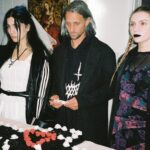 Nadezhda Tolokonnikova Instagram - 💍🔪🫀 american boy уеду с тобой @voguemagazine 📝: Sewing used to be a source of trauma for Pussy Riot’s Nadya Tolokonnikova, who was forced to stitch military and police uniforms while in a Russian penal colony. But she decided to reclaim the activity when she sewed Adidas stripes onto her now-husband John Caldwell’s suit jacket, for their wedding on 12 January. “Now I feel like I can sew again without being necessarily connected to the traumatic experience,” she says. “It broke the chain of trauma.” She wanted to create contrast between the “cute” side of her personality with the “gopnik” side. Tolokonnikova, who is vegan, juxtaposed her sweet look with an oversized black faux-leather Adidas jacket. She also wore a pair of velvet Doc Martens, though she changed into slides from—you guessed it—Adidas during the party. Tolokonnikova also included the Orthodox cross in her ceremony: on a necklace, garter belt, and even the vegan Napoleon cake covered in black icing, which she baked herself. “I’m almost trying to steal [the symbol] from the Orthodox Christianity, honestly, because they stole two years of my life,” she says. “I was accused—besides going against Putin—of religious hatred, which I didn’t have. But they still accused me of it. So I was like, Well, I’m just going to be using your symbol and reclaim it as my own.” She and Caldwell were married by Father Nathan Monk, who was excommunicated from the Russian Orthodox church for his support of the LGBTQ+ community, underneath a giant neon Orthodox cross. Photos: @marysergeevnaa Husbando: @vegsurfer Text: @hannahjacksuhn