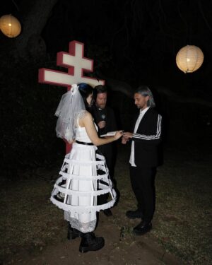 Nadezhda Tolokonnikova Instagram - 💒🔪🫀💍 и умерли в один день x @vegsurfer 

@nytimes 📝: Nathan Monk, a priest who left the Russian Orthodox Church because he did not support its stance on gay marriage, led a ceremony.

Ms. Tolokonnikova’s daughter @gerariot made the party’s playlist, which featured Soviet pop and contemporary Russian trap. For food, Ms. Tolokonnikova suggested serving pickles and vodka, but Mr. Caldwell insisted on something more robust.

Ms. Tolokonnikova baked a large vegan Napoleon cake, dyed it black and assembled it in the shape of a cross, a symbol she uses often in her artwork.

The dress code was “gopnik,” a word that encapsulates a style of dress, music and art reflecting the working class in the former Soviet states in the 1980s and 1990s. 

Guests showed up in tracksuits, house slippers, Adidas slides and newsboy caps, and one brought an accordion. 

Photos: @thecobrasnake 
Article: @vsaffron 
Priest: @fathernathan