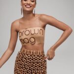 Natalia Fedner Instagram - Surprise!!! When @bloomingdales reached out to me about making a dress to celebrate the 50th anniversary of the Big Brown Bag - I was immediately on board! I wanted to bring my brand’s DNA to the project, while maintaining the integrity of the iconic Big Brown Bag kraft paper aesthetic. So I created a special chainmail made from actual Bloomingdale’s Big Brown Bags. This tiny paper chainmail, like my metal designs, is entirely hand made. The process starts by cutting the BBBs into 8.5 x 11” sheets, ironing them flat (yes, flashbacks to pressing paper patterns out at Parsons were had), then cutting the sheets into thousands of small strips using a hand held paper cutter (that I may have found tossed out on a street corner by my West Hollywood apartment…), and finally taping them together with little double sided tabs to create a honeycomb like pattern. I used this technique to create the skirt for the project, finishing it off with a Bloomingdales waistband (sourced from the side of the bag). The paper skirt is delicate, but because of the technique I developed for the project, it actually stretches quite a bit and allows a full range of movement! For the top, I wanted to design something a little more clean and simple that really focused on the theme. So I opted for a 90’s style bandeau top with the famous words front and center, integrating hand straps from actual bags to create shoulder straps for the top. By incorporating a few smart darts in the front and some corset work in the back, I was able to transition a Big Brown Bag into a Small Sleek Top. The overall silhouette of the look gives a wink to the 1950s, celebrating Bloomingdales lasting impact on fashion. Swipe through for a small taste of BTS - more to come! And yes model @lamekafox IS wearing a pair of our own chain earrings! Shoutout to @riowarner and @maya_adelle - this was a true labor of love that involved thousands of little movements - little cuts, little bits of tape - and these two rockstars made sure I got the project done in time by helping prep thousands of paper tabs for me. And thank you @p810km for being our fit model 🥰 Thank you @ela.ine.k @tatootsie for bringing me on!!
