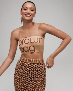 Natalia Fedner Instagram - Surprise!!! When @bloomingdales reached out to me about making a dress to celebrate the 50th anniversary of the Big Brown Bag - I was immediately on board! I wanted to bring my brand’s DNA to the project, while maintaining the integrity of the iconic Big Brown Bag kraft paper aesthetic. So I created a special chainmail made from actual Bloomingdale’s Big Brown Bags. This tiny paper chainmail, like my metal designs, is entirely hand made. The process starts by cutting the BBBs into 8.5 x 11” sheets, ironing them flat (yes, flashbacks to pressing paper patterns out at Parsons were had), then cutting the sheets into thousands of small strips using a hand held paper cutter (that I may have found tossed out on a street corner by my West Hollywood apartment…), and finally taping them together with little double sided tabs to create a honeycomb like pattern. I used this technique to create the skirt for the project, finishing it off with a Bloomingdales waistband (sourced from the side of the bag). The paper skirt is delicate, but because of the technique I developed for the project, it actually stretches quite a bit and allows a full range of movement! For the top, I wanted to design something a little more clean and simple that really focused on the theme. So I opted for a 90’s style bandeau top with the famous words front and center, integrating hand straps from actual bags to create shoulder straps for the top. By incorporating a few smart darts in the front and some corset work in the back, I was able to transition a Big Brown Bag into a Small Sleek Top. The overall silhouette of the look gives a wink to the 1950s, celebrating Bloomingdales lasting impact on fashion. Swipe through for a small taste of BTS - more to come! And yes model @lamekafox IS wearing a pair of our own chain earrings! 

Shoutout to @riowarner and @maya_adelle - this was a true labor of love that involved thousands of little movements - little cuts, little bits of tape - and these two rockstars made sure I got the project done in time by helping prep thousands of paper tabs for me. And thank you @p810km for being our fit model 🥰 Thank you @ela.ine.k @tatootsie for bringing me on!!