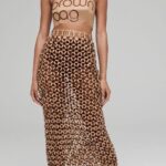 Natalia Fedner Instagram – How did I make the honeycomb paper chainmail skirt for @bloomingdales Big Brown Bag anniversary celebration? All the secrets are revealed in this video. The process starts by cutting the BBBs into 8.5 x 11β sheets, ironing them flat (yes, flashbacks to pressing paper patterns out at Parsons were had), then cutting the sheets into thousands of small strips using a hand held paper cutter (that I may have found tossed out on a street corner by my West Hollywood apartmentβ¦), and finally taping them together with little double sided tabs to create a honeycomb like pattern. I used this technique to create the skirt for the project, finishing it off with a Bloomingdales waistband (sourced from the side of the bag). The paper skirt is delicate, but because of the technique I developed for the project, it actually stretches quite a bit and allows a full range of movement!
#bigbrownbag #paperart #paper #papercrafts #bloomingdales #kraftpaper #garlands #diy #paperdress