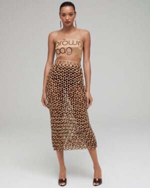 Natalia Fedner Instagram - Surprise!!! When @bloomingdales reached out to me about making a dress to celebrate the 50th anniversary of the Big Brown Bag - I was immediately on board! I wanted to bring my brand’s DNA to the project, while maintaining the integrity of the iconic Big Brown Bag kraft paper aesthetic. So I created a special chainmail made from actual Bloomingdale’s Big Brown Bags. This tiny paper chainmail, like my metal designs, is entirely hand made. The process starts by cutting the BBBs into 8.5 x 11” sheets, ironing them flat (yes, flashbacks to pressing paper patterns out at Parsons were had), then cutting the sheets into thousands of small strips using a hand held paper cutter (that I may have found tossed out on a street corner by my West Hollywood apartment…), and finally taping them together with little double sided tabs to create a honeycomb like pattern. I used this technique to create the skirt for the project, finishing it off with a Bloomingdales waistband (sourced from the side of the bag). The paper skirt is delicate, but because of the technique I developed for the project, it actually stretches quite a bit and allows a full range of movement! For the top, I wanted to design something a little more clean and simple that really focused on the theme. So I opted for a 90’s style bandeau top with the famous words front and center, integrating hand straps from actual bags to create shoulder straps for the top. By incorporating a few smart darts in the front and some corset work in the back, I was able to transition a Big Brown Bag into a Small Sleek Top. The overall silhouette of the look gives a wink to the 1950s, celebrating Bloomingdales lasting impact on fashion. Swipe through for a small taste of BTS - more to come! And yes model @lamekafox IS wearing a pair of our own chain earrings! 

Shoutout to @riowarner and @maya_adelle - this was a true labor of love that involved thousands of little movements - little cuts, little bits of tape - and these two rockstars made sure I got the project done in time by helping prep thousands of paper tabs for me. And thank you @p810km for being our fit model 🥰 Thank you @ela.ine.k @tatootsie for bringing me on!!