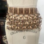 Natalia Fedner Instagram - Surprise!!! When @bloomingdales reached out to me about making a dress to celebrate the 50th anniversary of the Big Brown Bag - I was immediately on board! I wanted to bring my brand’s DNA to the project, while maintaining the integrity of the iconic Big Brown Bag kraft paper aesthetic. So I created a special chainmail made from actual Bloomingdale’s Big Brown Bags. This tiny paper chainmail, like my metal designs, is entirely hand made. The process starts by cutting the BBBs into 8.5 x 11” sheets, ironing them flat (yes, flashbacks to pressing paper patterns out at Parsons were had), then cutting the sheets into thousands of small strips using a hand held paper cutter (that I may have found tossed out on a street corner by my West Hollywood apartment…), and finally taping them together with little double sided tabs to create a honeycomb like pattern. I used this technique to create the skirt for the project, finishing it off with a Bloomingdales waistband (sourced from the side of the bag). The paper skirt is delicate, but because of the technique I developed for the project, it actually stretches quite a bit and allows a full range of movement! For the top, I wanted to design something a little more clean and simple that really focused on the theme. So I opted for a 90’s style bandeau top with the famous words front and center, integrating hand straps from actual bags to create shoulder straps for the top. By incorporating a few smart darts in the front and some corset work in the back, I was able to transition a Big Brown Bag into a Small Sleek Top. The overall silhouette of the look gives a wink to the 1950s, celebrating Bloomingdales lasting impact on fashion. Swipe through for a small taste of BTS - more to come! And yes model @lamekafox IS wearing a pair of our own chain earrings! Shoutout to @riowarner and @maya_adelle - this was a true labor of love that involved thousands of little movements - little cuts, little bits of tape - and these two rockstars made sure I got the project done in time by helping prep thousands of paper tabs for me. And thank you @p810km for being our fit model 🥰 Thank you @ela.ine.k @tatootsie for bringing me on!!