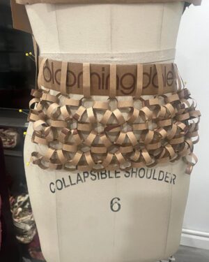 Natalia Fedner Instagram - Surprise!!! When @bloomingdales reached out to me about making a dress to celebrate the 50th anniversary of the Big Brown Bag - I was immediately on board! I wanted to bring my brand’s DNA to the project, while maintaining the integrity of the iconic Big Brown Bag kraft paper aesthetic. So I created a special chainmail made from actual Bloomingdale’s Big Brown Bags. This tiny paper chainmail, like my metal designs, is entirely hand made. The process starts by cutting the BBBs into 8.5 x 11” sheets, ironing them flat (yes, flashbacks to pressing paper patterns out at Parsons were had), then cutting the sheets into thousands of small strips using a hand held paper cutter (that I may have found tossed out on a street corner by my West Hollywood apartment…), and finally taping them together with little double sided tabs to create a honeycomb like pattern. I used this technique to create the skirt for the project, finishing it off with a Bloomingdales waistband (sourced from the side of the bag). The paper skirt is delicate, but because of the technique I developed for the project, it actually stretches quite a bit and allows a full range of movement! For the top, I wanted to design something a little more clean and simple that really focused on the theme. So I opted for a 90’s style bandeau top with the famous words front and center, integrating hand straps from actual bags to create shoulder straps for the top. By incorporating a few smart darts in the front and some corset work in the back, I was able to transition a Big Brown Bag into a Small Sleek Top. The overall silhouette of the look gives a wink to the 1950s, celebrating Bloomingdales lasting impact on fashion. Swipe through for a small taste of BTS - more to come! And yes model @lamekafox IS wearing a pair of our own chain earrings! 

Shoutout to @riowarner and @maya_adelle - this was a true labor of love that involved thousands of little movements - little cuts, little bits of tape - and these two rockstars made sure I got the project done in time by helping prep thousands of paper tabs for me. And thank you @p810km for being our fit model 🥰 Thank you @ela.ine.k @tatootsie for bringing me on!!