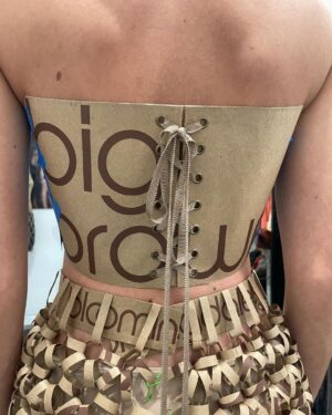 Natalia Fedner Instagram - Surprise!!! When @bloomingdales reached out to me about making a dress to celebrate the 50th anniversary of the Big Brown Bag - I was immediately on board! I wanted to bring my brand’s DNA to the project, while maintaining the integrity of the iconic Big Brown Bag kraft paper aesthetic. So I created a special chainmail made from actual Bloomingdale’s Big Brown Bags. This tiny paper chainmail, like my metal designs, is entirely hand made. The process starts by cutting the BBBs into 8.5 x 11” sheets, ironing them flat (yes, flashbacks to pressing paper patterns out at Parsons were had), then cutting the sheets into thousands of small strips using a hand held paper cutter (that I may have found tossed out on a street corner by my West Hollywood apartment…), and finally taping them together with little double sided tabs to create a honeycomb like pattern. I used this technique to create the skirt for the project, finishing it off with a Bloomingdales waistband (sourced from the side of the bag). The paper skirt is delicate, but because of the technique I developed for the project, it actually stretches quite a bit and allows a full range of movement! For the top, I wanted to design something a little more clean and simple that really focused on the theme. So I opted for a 90’s style bandeau top with the famous words front and center, integrating hand straps from actual bags to create shoulder straps for the top. By incorporating a few smart darts in the front and some corset work in the back, I was able to transition a Big Brown Bag into a Small Sleek Top. The overall silhouette of the look gives a wink to the 1950s, celebrating Bloomingdales lasting impact on fashion. Swipe through for a small taste of BTS - more to come! And yes model @lamekafox IS wearing a pair of our own chain earrings! 

Shoutout to @riowarner and @maya_adelle - this was a true labor of love that involved thousands of little movements - little cuts, little bits of tape - and these two rockstars made sure I got the project done in time by helping prep thousands of paper tabs for me. And thank you @p810km for being our fit model 🥰 Thank you @ela.ine.k @tatootsie for bringing me on!!