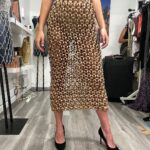 Natalia Fedner Instagram – Surprise!!! When @bloomingdales reached out to me about making a dress to celebrate the 50th anniversary of the Big Brown Bag – I was immediately on board! I wanted to bring my brand’s DNA to the project, while maintaining the integrity of the iconic Big Brown Bag kraft paper aesthetic. So I created a special chainmail made from actual Bloomingdale’s Big Brown Bags. This tiny paper chainmail, like my metal designs, is entirely hand made. The process starts by cutting the BBBs into 8.5 x 11” sheets, ironing them flat (yes, flashbacks to pressing paper patterns out at Parsons were had), then cutting the sheets into thousands of small strips using a hand held paper cutter (that I may have found tossed out on a street corner by my West Hollywood apartment…), and finally taping them together with little double sided tabs to create a honeycomb like pattern. I used this technique to create the skirt for the project, finishing it off with a Bloomingdales waistband (sourced from the side of the bag). The paper skirt is delicate, but because of the technique I developed for the project, it actually stretches quite a bit and allows a full range of movement! For the top, I wanted to design something a little more clean and simple that really focused on the theme. So I opted for a 90’s style bandeau top with the famous words front and center, integrating hand straps from actual bags to create shoulder straps for the top. By incorporating a few smart darts in the front and some corset work in the back, I was able to transition a Big Brown Bag into a Small Sleek Top. The overall silhouette of the look gives a wink to the 1950s, celebrating Bloomingdales lasting impact on fashion. Swipe through for a small taste of BTS – more to come! And yes model @lamekafox IS wearing a pair of our own chain earrings! 

Shoutout to @riowarner and @maya_adelle – this was a true labor of love that involved thousands of little movements – little cuts, little bits of tape – and these two rockstars made sure I got the project done in time by helping prep thousands of paper tabs for me. And thank you @p810km for being our fit model 🥰 Thank you @ela.ine.k @tatootsie for bringing me on!!