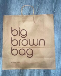 Natalia Fedner Instagram - Surprise!!! When @bloomingdales reached out to me about making a dress to celebrate the 50th anniversary of the Big Brown Bag - I was immediately on board! I wanted to bring my brand’s DNA to the project, while maintaining the integrity of the iconic Big Brown Bag kraft paper aesthetic. So I created a special chainmail made from actual Bloomingdale’s Big Brown Bags. This tiny paper chainmail, like my metal designs, is entirely hand made. The process starts by cutting the BBBs into 8.5 x 11” sheets, ironing them flat (yes, flashbacks to pressing paper patterns out at Parsons were had), then cutting the sheets into thousands of small strips using a hand held paper cutter (that I may have found tossed out on a street corner by my West Hollywood apartment…), and finally taping them together with little double sided tabs to create a honeycomb like pattern. I used this technique to create the skirt for the project, finishing it off with a Bloomingdales waistband (sourced from the side of the bag). The paper skirt is delicate, but because of the technique I developed for the project, it actually stretches quite a bit and allows a full range of movement! For the top, I wanted to design something a little more clean and simple that really focused on the theme. So I opted for a 90’s style bandeau top with the famous words front and center, integrating hand straps from actual bags to create shoulder straps for the top. By incorporating a few smart darts in the front and some corset work in the back, I was able to transition a Big Brown Bag into a Small Sleek Top. The overall silhouette of the look gives a wink to the 1950s, celebrating Bloomingdales lasting impact on fashion. Swipe through for a small taste of BTS - more to come! And yes model @lamekafox IS wearing a pair of our own chain earrings! Shoutout to @riowarner and @maya_adelle - this was a true labor of love that involved thousands of little movements - little cuts, little bits of tape - and these two rockstars made sure I got the project done in time by helping prep thousands of paper tabs for me. And thank you @p810km for being our fit model 🥰 Thank you @ela.ine.k @tatootsie for bringing me on!!