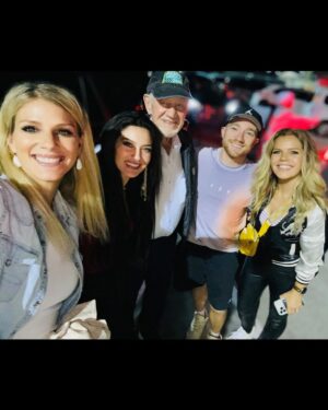 Natalie Stovall Instagram - 🏁 Bristol Baby!! 🏁 
When I was little, my big brother, Joe, would have his friends over every weekend for the @nascar races. And inevitably, when a break would happen, there was always a “Natalie! Go get your fiddle!” So I’d play a few songs and feel like the coolest kid around. 
Fast forward to this past weekend, I attended my very first race, in the “coolest kid” way possible… (thank you @quartzhillrecords 🤍🥂) and I found myself again playing that fiddle, as us ladies did a little acoustic set for some VIP’s. It was so much fun cheering for @tyler_reddick and getting to soak it all in! What an experience!!! Swipe to the end to see Joe-Bob and little me.