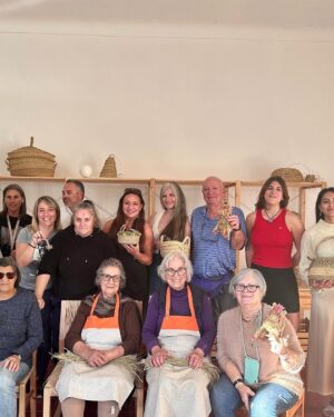 Norah Casey Instagram - As the temperature hit 25 degrees we headed up to the village of Sarnadas in the parish of Alte and a little weaving workshop, Casa do Esparto,  based  in the repurposed Escola Primária das Sarnadas. It’s one of a network of artisan spaces of the Loulé Criativo project which is revitalising ancient creative traditions in the region. There I met this wonderful woman Donna Aldegundes Gomes, born in the village, she proudly tells me she’s 89 years old and 60 years a weaver. She has a big heart, skilful hands and a wide smile. You can tell she loves what she does. Now she is passing on her knowledge to new generations and enthusiastic amateurs like me. She and the other women in the collective use Esparto grass which grows wild in this area - the Barrocal lands of the Algarve interior. Essential back in the day for carpets, rugs, baskets and much more, the women are bringing back the traditional method and weaving patterns to create lovely unique pieces, some decorative, many practical. I was in the baby class making key rings which was a lovely hands-on, gentle and calming experience. Hands touching hands, heads bent close together nudging the grasses into new shapes and patterns. #creativityinaction @loule_criativo @visitalgarve