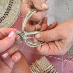Norah Casey Instagram - As the temperature hit 25 degrees we headed up to the village of Sarnadas in the parish of Alte and a little weaving workshop, Casa do Esparto, based in the repurposed Escola Primária das Sarnadas. It’s one of a network of artisan spaces of the Loulé Criativo project which is revitalising ancient creative traditions in the region. There I met this wonderful woman Donna Aldegundes Gomes, born in the village, she proudly tells me she’s 89 years old and 60 years a weaver. She has a big heart, skilful hands and a wide smile. You can tell she loves what she does. Now she is passing on her knowledge to new generations and enthusiastic amateurs like me. She and the other women in the collective use Esparto grass which grows wild in this area - the Barrocal lands of the Algarve interior. Essential back in the day for carpets, rugs, baskets and much more, the women are bringing back the traditional method and weaving patterns to create lovely unique pieces, some decorative, many practical. I was in the baby class making key rings which was a lovely hands-on, gentle and calming experience. Hands touching hands, heads bent close together nudging the grasses into new shapes and patterns. #creativityinaction @loule_criativo @visitalgarve