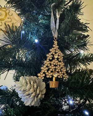 Norah Casey Instagram - Of course as we go through life Christmas also reminds us of absences, the family and loved ones we miss, those who have gone and those who can’t be with us. Like many people I have certainly been through difficult Christmases and it takes time to rediscover the wonderfulness. 
And I’m always late putting up the tree… but I get there eventually 😅
When I was growing up the tree didn’t go up until Christmas week. 
It was all about the excitement and anticipation. And thankfully the pre-Christmas flutters were mercifully short, starting when the school bell signalled the start of the holidays and we raced home to help put up the tree, just days before the big day. My dad brought down the biscuit tin filled with tinsel and home made decorations by the Casey kids. It also held a very important list… and it wasn’t Santy’s! My dad #harrycasey wrote down the price of the pint every Christmas and he ceremoniously filled in the cost bemoaning the tragedy of Guinness inflation while we fought over who would place the star on the top of the tree. Mostly our home was filled with holly and fir from the Phoenix Park and we had our own reindeer waiting patiently on those frosty days for Santy to collect them on Christmas Eve. What could be more magical. 
I like reusing those lovely treasured pieces from over the years that remind me of Dara’s first Christmas, the trip to London when myself and a great friend bought some (far too high-priced) baubles in Harrods, the now very chipped, but rich with memories, crib and bits and bobs that we collected on holidays. I take them all up from the basement and mix them up a bit so every year the house looks different. Last year I splashed out on some green tree decorations to mix in with the mainly white and gold that I have collected for decades. It is always beautiful to me and yours will be the same, however you choose to transform your home for the festive season… Christmas Trees are #memorytrees🎄 💚