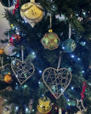 Norah Casey Instagram - Of course as we go through life Christmas also reminds us of absences, the family and loved ones we miss, those who have gone and those who can’t be with us. Like many people I have certainly been through difficult Christmases and it takes time to rediscover the wonderfulness. 
And I’m always late putting up the tree… but I get there eventually 😅
When I was growing up the tree didn’t go up until Christmas week. 
It was all about the excitement and anticipation. And thankfully the pre-Christmas flutters were mercifully short, starting when the school bell signalled the start of the holidays and we raced home to help put up the tree, just days before the big day. My dad brought down the biscuit tin filled with tinsel and home made decorations by the Casey kids. It also held a very important list… and it wasn’t Santy’s! My dad #harrycasey wrote down the price of the pint every Christmas and he ceremoniously filled in the cost bemoaning the tragedy of Guinness inflation while we fought over who would place the star on the top of the tree. Mostly our home was filled with holly and fir from the Phoenix Park and we had our own reindeer waiting patiently on those frosty days for Santy to collect them on Christmas Eve. What could be more magical. 
I like reusing those lovely treasured pieces from over the years that remind me of Dara’s first Christmas, the trip to London when myself and a great friend bought some (far too high-priced) baubles in Harrods, the now very chipped, but rich with memories, crib and bits and bobs that we collected on holidays. I take them all up from the basement and mix them up a bit so every year the house looks different. Last year I splashed out on some green tree decorations to mix in with the mainly white and gold that I have collected for decades. It is always beautiful to me and yours will be the same, however you choose to transform your home for the festive season… Christmas Trees are #memorytrees🎄 💚