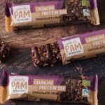 Pamela Reif Instagram - Dennis Limited Edition!! 🎈🫣 Which Team are you in? 👀 an Oatbar for all se Feinschmeckers 😮‍💨 this time it’s not a joke 😂😂 1. Team Dennis 🧋Imagine combining my best Oat Bar with the BEST Chai Latte & adding vegan white choc chunks and even more creaminess 🍦Something unique, far different than standard range. Because Dennis… would never do something boring 😅 We are sure you have NOT tasted something like this before! 2. Team Pam 🍫 Are you a chocolate lover? And want to treat your muscles with protein? While still not eating “too many” calories? My newest flavour is making me proud! The Chocolate Crisp is chocolatey like neverrrr before! Compared to the other flavours it tastes richer, more chocolatey and a hint sweeter and fuller 💪🏼 However, it’s still a „performance“ protein bar with only 126kcal, only 7g of carbs and 4g of sugar (that’s so low!) and a high fiber content, that will keep you full. So: Do you need a super light snack, that satisfies your wish for chocolate but doesn’t feel like a „cheat“? This is it. 🌱 both are organic, vegan, gluten free, without artificial sweeteners / colorants / flavourings or preservatives & made with loooooove ➡️ www.naturally-pam.com available as long as stock lasts on Let us know what you think, Dennis is so hyped to finally have his own Limited Edition!! #new #launchday #sibilings #wohoo #chai #chocolate #pamelareif #naturallypam Out Now