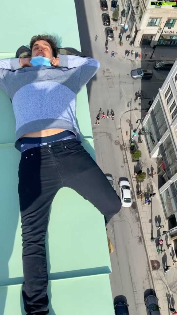 Parkourporpoise Instagram - Just hanging out over the city! #Rooftopstunt #adrenaline #reels Ps everybody looks like ants down there! 🐜🤪 Montreal, Quebec