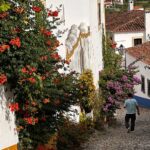 Patricia Heaton Instagram - On the way back to Lisbon from Nazaré we stopped in Óbidos, one of the most beautifully preserved villages I’ve ever visited. Beautiful cobbled streets lined with historic buildings drenched in flowers. Obidos Portugal