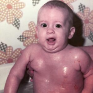 Penn Holderness Instagram - Happy Veterans day! This early double chin is  from 1974. The hand propping me up belongs to my dad, who served in the US Army during the Cuban Missile crisis. Thanks for keeping me safe dad, both in the tub and in the Army! #doublechinstagram #veteransday