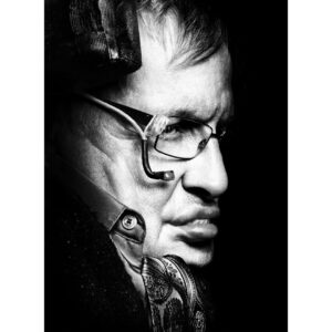 Platon Instagram - stephen hawking. "Professor Hawking's physical condition during the session must have been extremely challenging for him. As far as I could tell, one of the last functioning muscles in his body was around his right eye. In this picture you can see a sensor has been fitted to his glasses to monitor movement. Thus, he can direct a cursor over each letter in the alphabet on a computer until he makes a selection: LETTERS - WORDS - SENTENCES - PARAGRAPHS. The world’s greatest free mind is imprisoned in the most fragile and limited body. By the end of my sitting he was clearly exhausted. Just keeping his eyes open was a mountain to climb. Knowing he had given his all, I asked if he could slip me a single word of wisdom - one word about life from Professor Stephen Hawking was bound to be prophetic. His nurse explained that when he is tired his powers of communication are less accurate. She suggested that we let him be. As I packed up to leave I heard beeps coming from the professor’s tablet monitor.  We all turned to see him moving the cursor over each letter. 'HE'S TYPING!' With each beep we all leaned in with anticipation - He stopped at the letter ‘W.’ “I doubt that is accurate,” said his carer. Then the search for the second letter began - BEEP BEEP BEEP until the letter ‘O.’ Once again his nurse seemed doubtful. “W - O, it doesn't mean anything.” Then his beeps began for a third and final time. BEEP BEEP BEEP - all the way back to the letter 'W' again. Before the nurse could interpret, it hit me, “Oh my God,” I shouted. “He typed the word WOW!” My heart raced as I squeezed his hand, “Thank you professor,” I whispered. Despite this man’s overwhelming adversity, he still believes in the mighty power of WOW. How lucky I am to receive such an important philosophical lesson in optimism. In the face of life's challenges, a courageous human being looks at the world with wonder. Professor Hawking, I salute you and the power of WOW.
