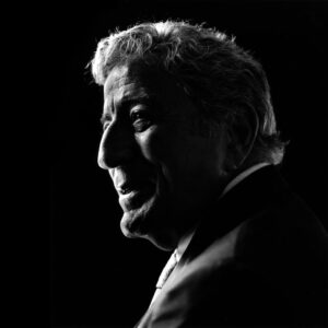 Platon Instagram - I photographed Tony Bennett a couple of times both in New York. I loved this man. He was sweet, humble and at peace with himself. He talked for hours about his love of music and musicians—Count Basie, Bill Evans, Billie Holiday, Buddy Rich, and of course, Sinatra, who had once described Tony as the “the best singer in the business.” Tony Bennett was also a painter and he compared the process of mixing colors with singing, especially singing jazz. I am showing you all two of my favorite pictures. I took the color image with my usual light and background. Tony, for a few brief moments, had paused—“What are you thinking about?” I asked. “Bill Evans’ sound,” he replied, “—solitude.” After we had packed up all the studio equipment it was time to leave. Tony was sitting by a window waiting for his lunch. A shaft of natural light caught his profile. Without saying anything I gently unpacked my Hasselblad and guessed the light reading [I didn’t want to disturb the moment]. I took four black and white frames and gently repacked my camera, thinking he hadn’t noticed. “Did you get it?” Tony asked without moving. “I got it,” I said. “My gift to you,” he replied. I left that day on an all time high. Some years later I was in LA with my mum. We were sitting in my favorite diner on Sunset Boulevard. I had some big news to deliver and I was shaking. “Mum,” I said, “I’m going to be a dad.” As my mum touched my hand, a song came on the jukebox—I LEFT MY HEART IN SAN FRANCISCO. We sat in silence listening to Tony Bennett’s beautiful reassuring sound and of course the song ended with the words “your golden sun will shine for me.” Tony Bennett—the day you passed, America lost a little bit of it’s soul. I salute you. Rest In Peace.