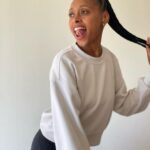 Rae Wynn-Grant Instagram - A lot’s been going on since I last posted (personally & in the world) but would rather focus on how I got my hair braided & look like a @onepeloton instructor & managed to wear a white shirt for a full half-day before getting it stained. It’s the little things sometimes. Also, we’ve been living with a blank bedroom wall for almost 2 years - pls send art recs 🙏🏾. Braids by @alicianicole186 Paparazzi pics by @daveseligman Unintentionally asymmetrical ear piercings by @clairesstores circa 1991 Santa Barbara, California