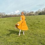 Rebecca Flint Instagram - Spring’s first light filling the pages with shimmering delight ☀️  Feeling very little women, in my @sondeflor classic short sleeve dress in marigold 🌻  made from 100% locally sourced Lithuanian linen and free shipping right now 😊 #thisjaneaustenlife #ofwhimsicalmoments #fairycore #cottagefairy #asecondofwhimsey #wherefairiesdwell #theheartofslowliving #softcore #coquetteaesthetic #parisiennegirl #thatvelvetfeeling #dreaminginpictures #amomentofwonder #ofquietmoments #whimsicalwonderfulwild #meadowcore #gardencore #warmcore #vintagecore #aseasonalshift #embracingtheseasons #quietchaotics #naturecore #lafemmeparisienne #monlook #onparledemode #romanticstyle #softgirlaesthetic #fashionhistory #springoutfitideas