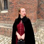 Rebecca Flint Instagram – if you can’t wear a cape in hampton court palace i’m not sure where you can 🌹?

I have always wanted to see this incredible tudor palace for myself and I was so excited to have the chance!

they had live cooking demonstrations inside the original kitchens, and we saw so many amazing tapestries and paintings… incredible day to visit!

the puff headband trend always reminds me of the French Hood so I had to wear this army green one, along with this spectacular velvet and silk cape picked up from @classiccarbootsale in the spring! My dress is vintage from Japan, and my bag is @aspinaloflondon. The shoes are @empressaustralia 🔍

Not forgetting my B necklace as an homage to Anne 🅱️❤️ Hampton Court Palace